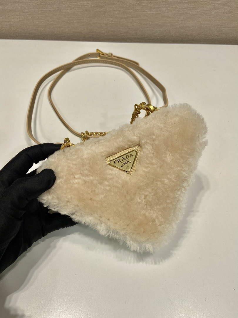 Prada 1NR015 Shearling and Saffiano leather mini-pouch Gold